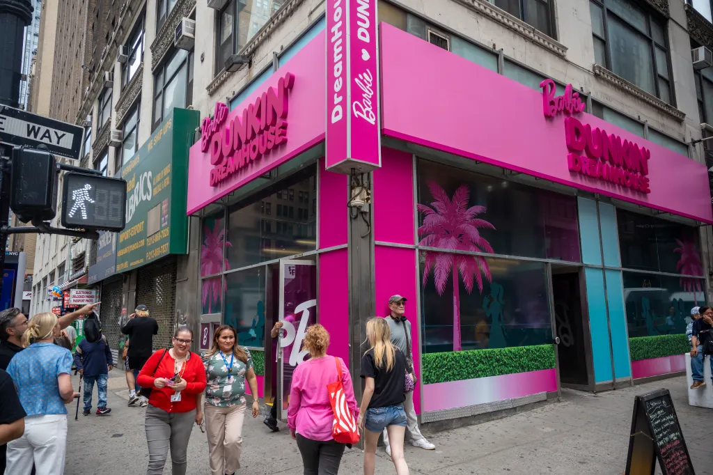 The exterior of a Dunkin' Dreamhouse store, painted bright pink with