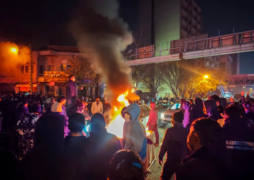 Protesters gather around a bonfire in Tehran, Iran.