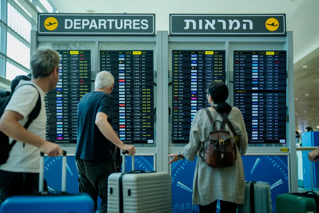 Passengers check the departure board at Ben Gurion International Airport in Tel Aviv, Israel, following Iranian missile strikes.