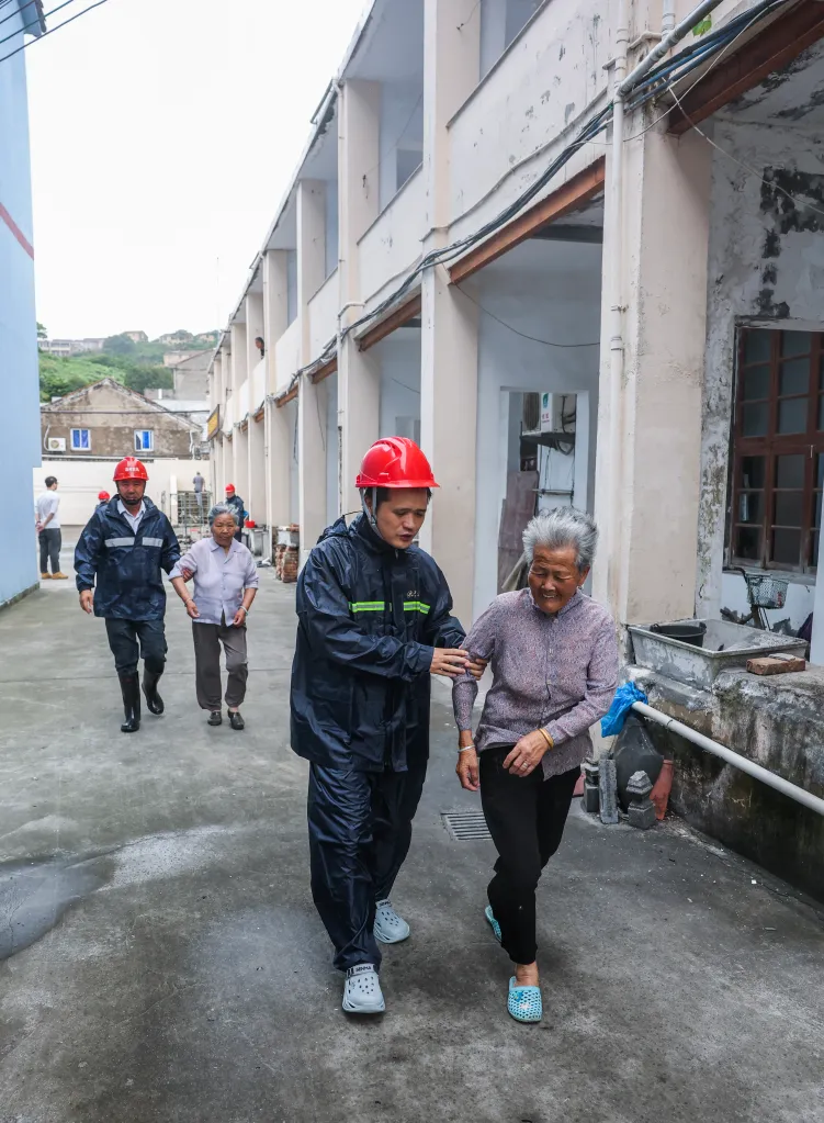Senior citizens are evacuated from their homes to a temporary shelter ahead of Typhoon Bavi in Wenling, China, on July 11, 2026.