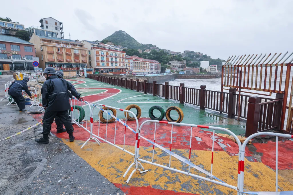 Workers set up barricades near the water to prevent people from entering the dangerous areas on July 11, 2026.