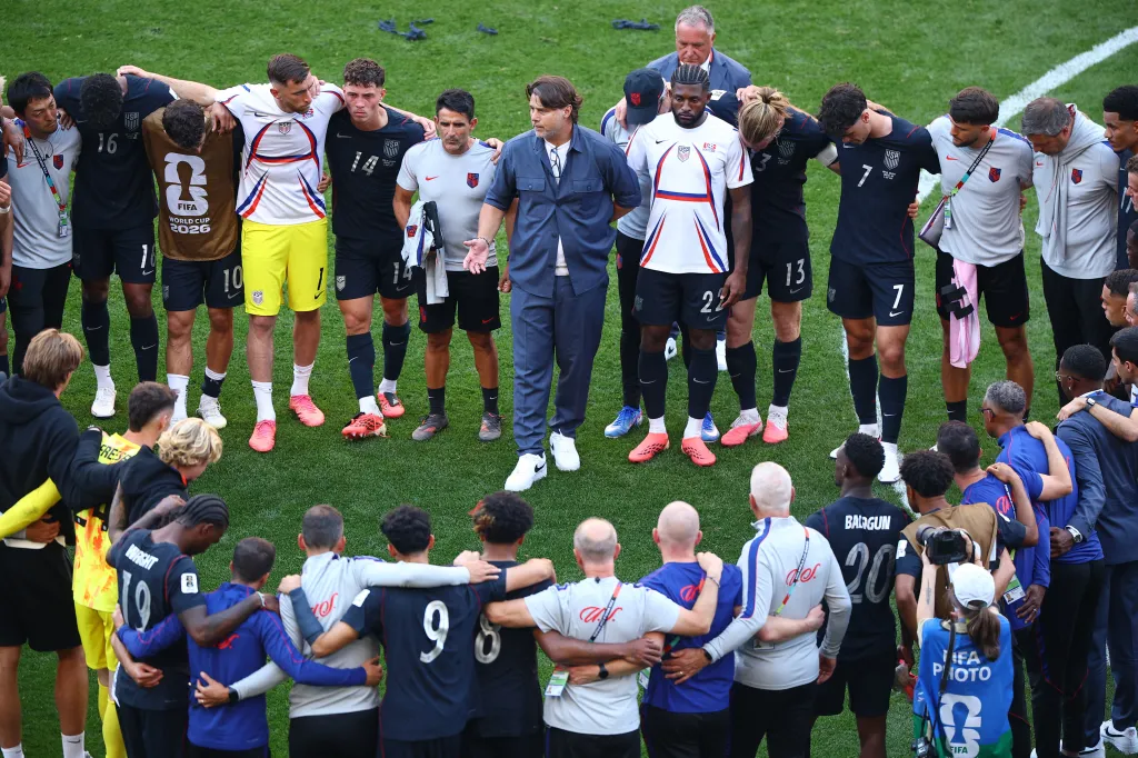 U.S. coach Mauricio Pochettino speaks to the team after they were eliminated from the World Cup.
