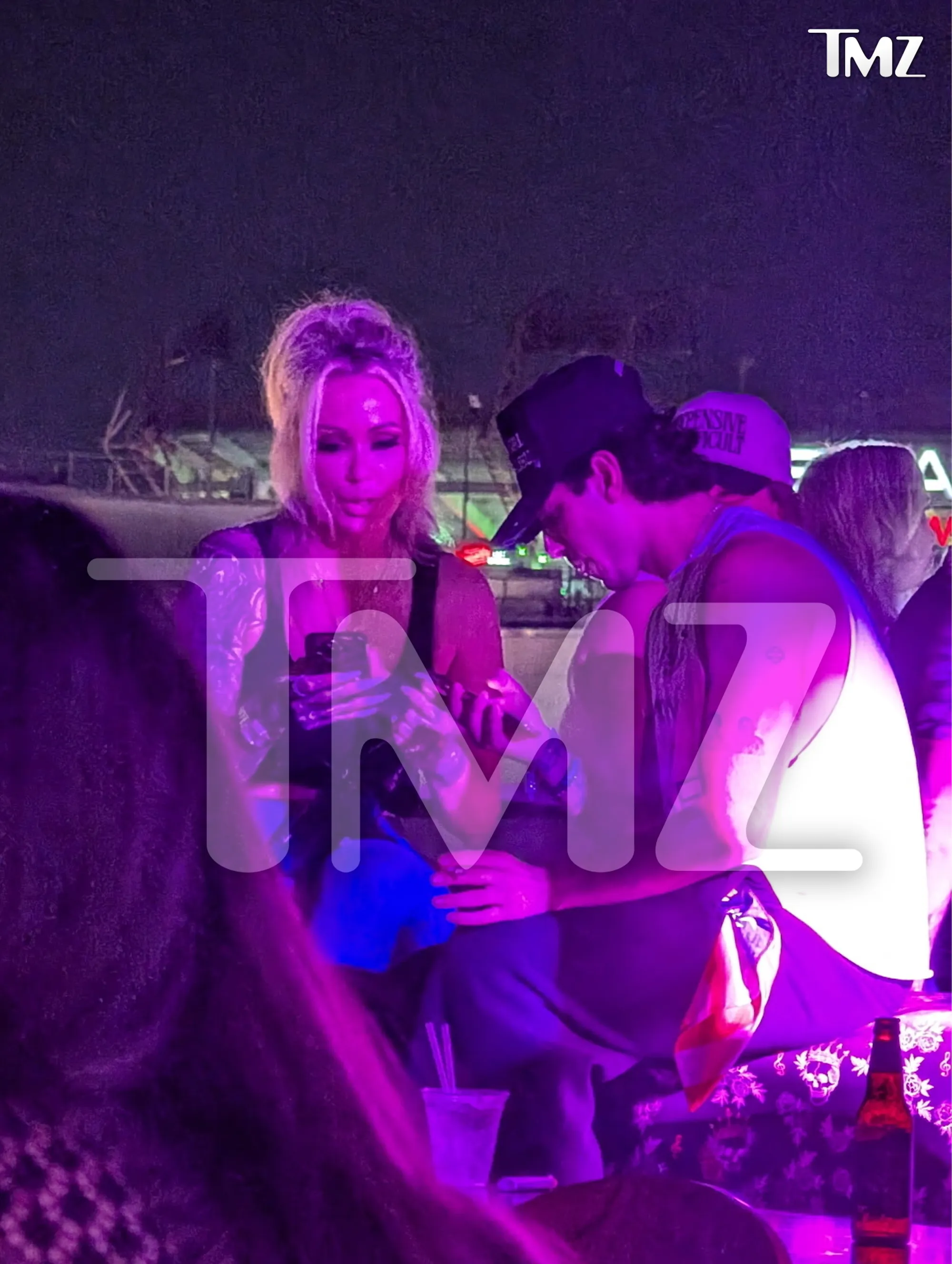 Bunnie Xo and Dylan Wolf chatting and laughing together at night.