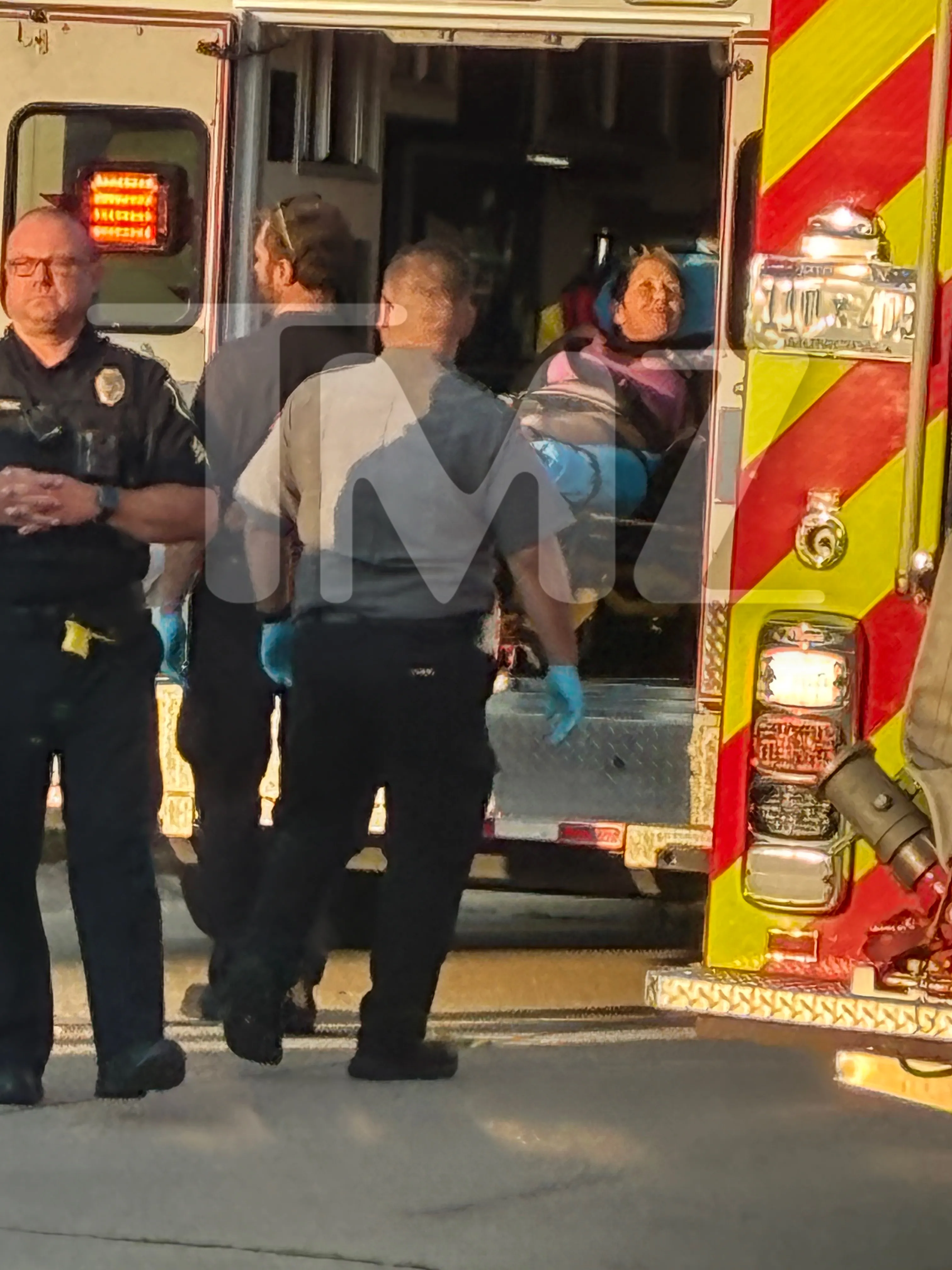 Kim Scott being transported in an ambulance.