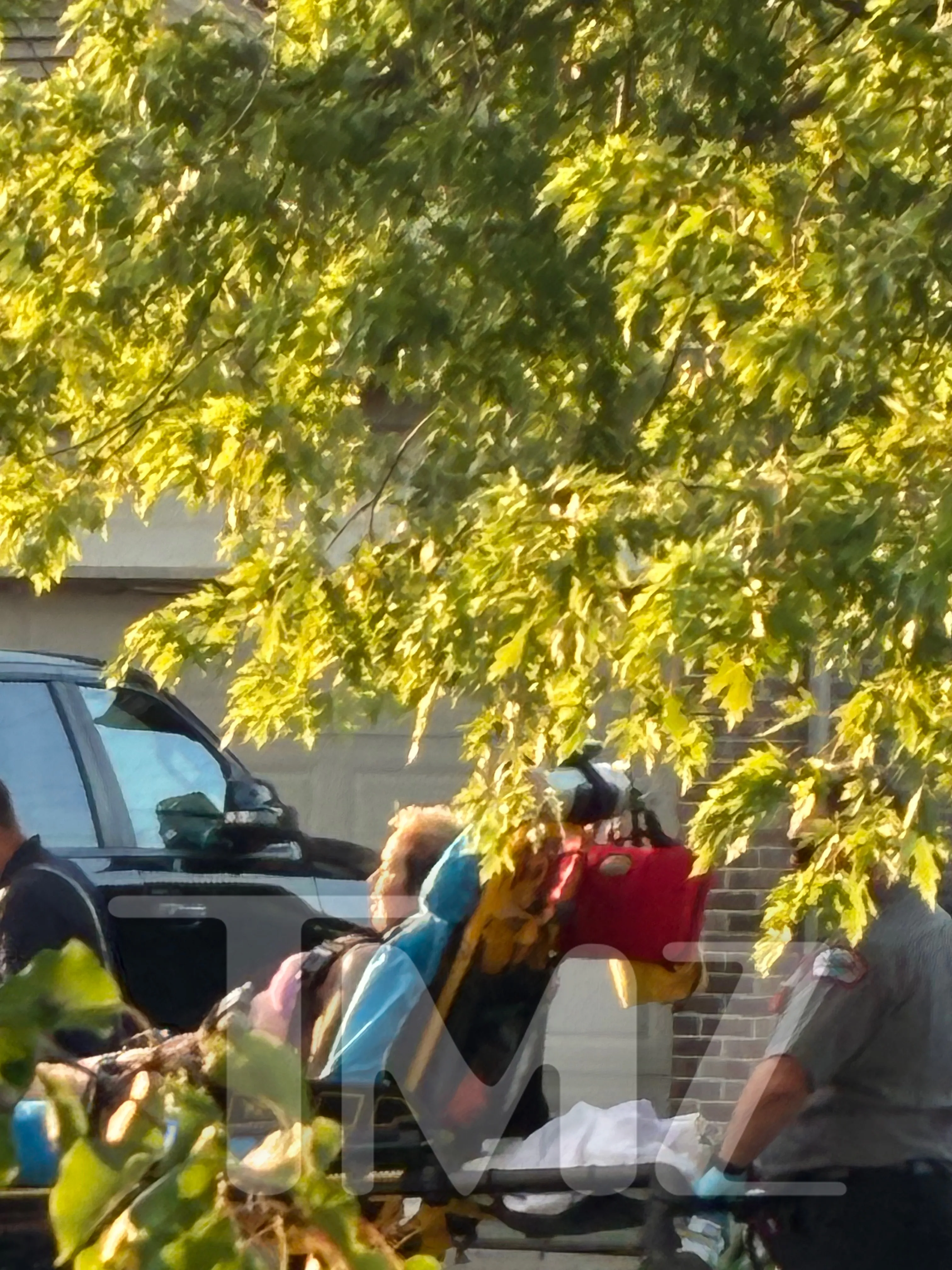Kim Scott, Eminem's ex-wife, on a stretcher being moved by paramedics.