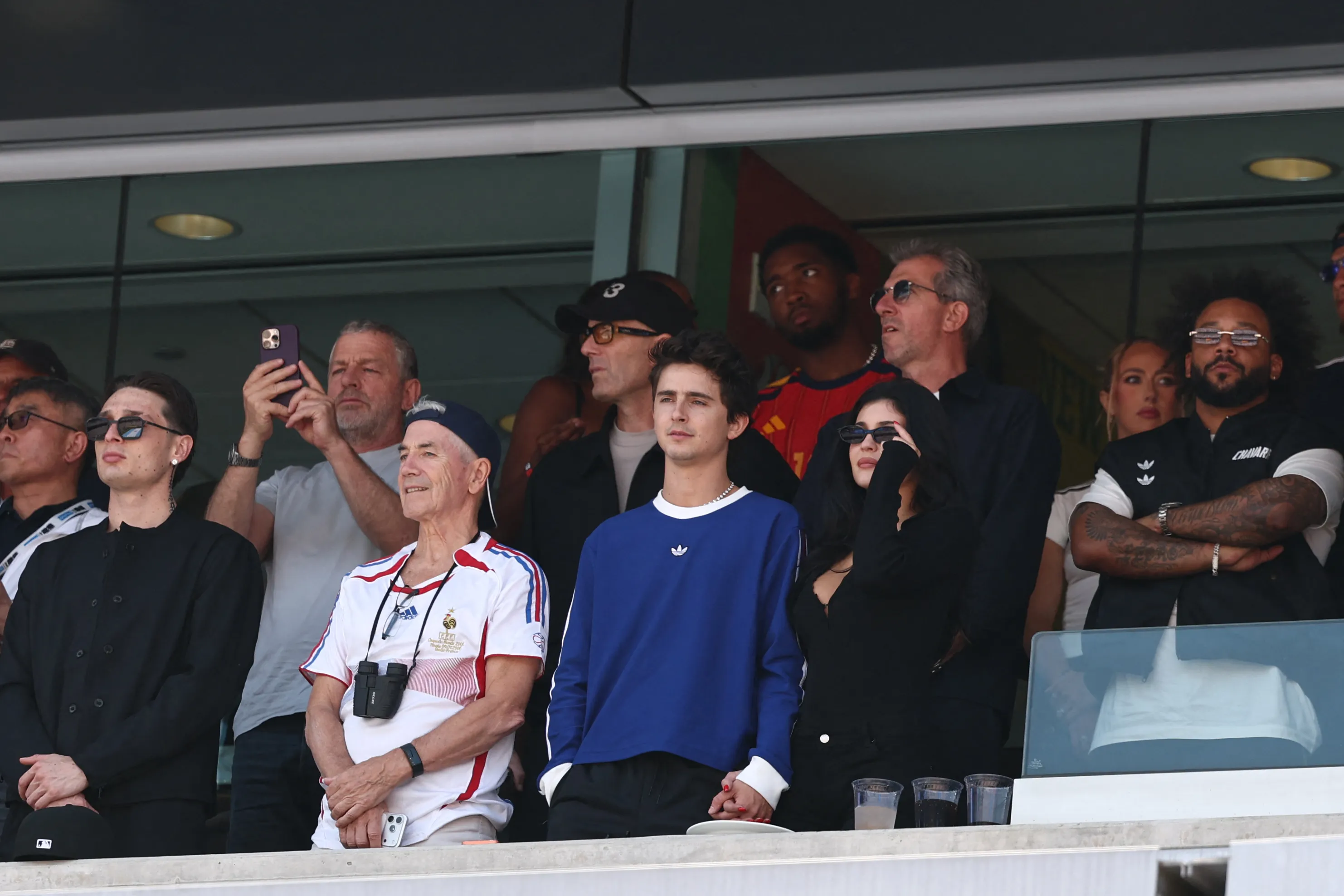Celebrities including Peso Pluma, Marc Chalamet, Timothee Chalamet, Kylie Jenner, Marcelo, and Zinedine Zidane watch the 2026 World Cup final.