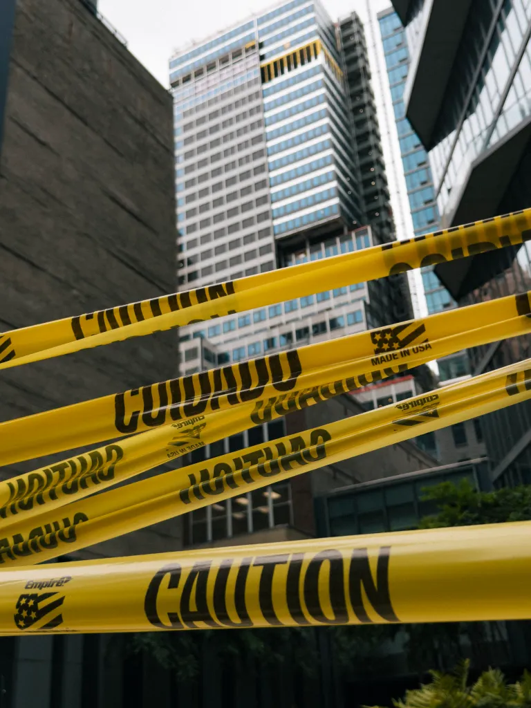 Yellow caution tape blocking access to an unstable building in Midtown Manhattan.
