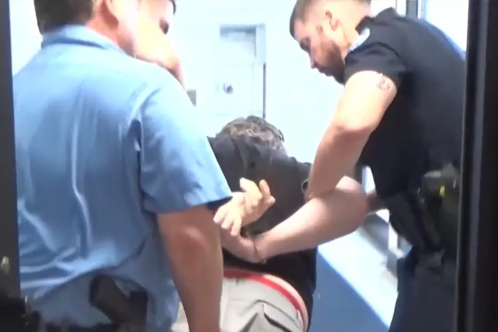 Police officers arresting a teacher.