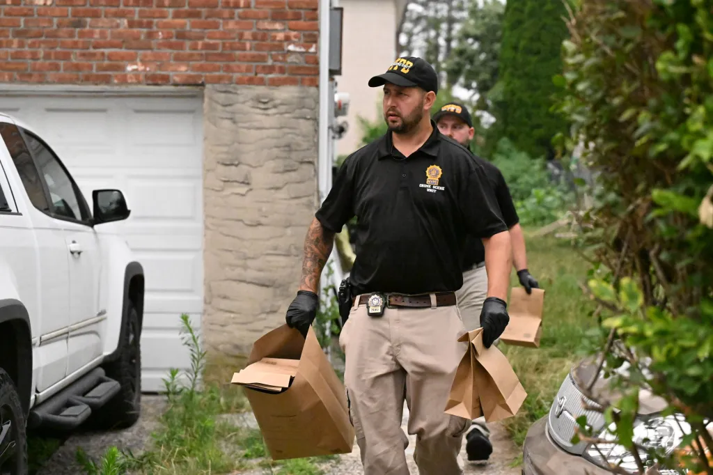 NYPD Crime Scene Unit members carrying evidence bags.