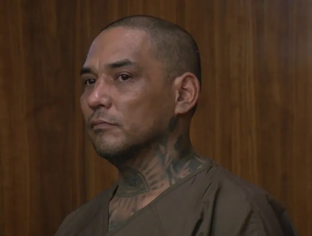 A 44-year-old man, Luis Villachana, with a shaved head and tattoos on his neck, looking off to the left.