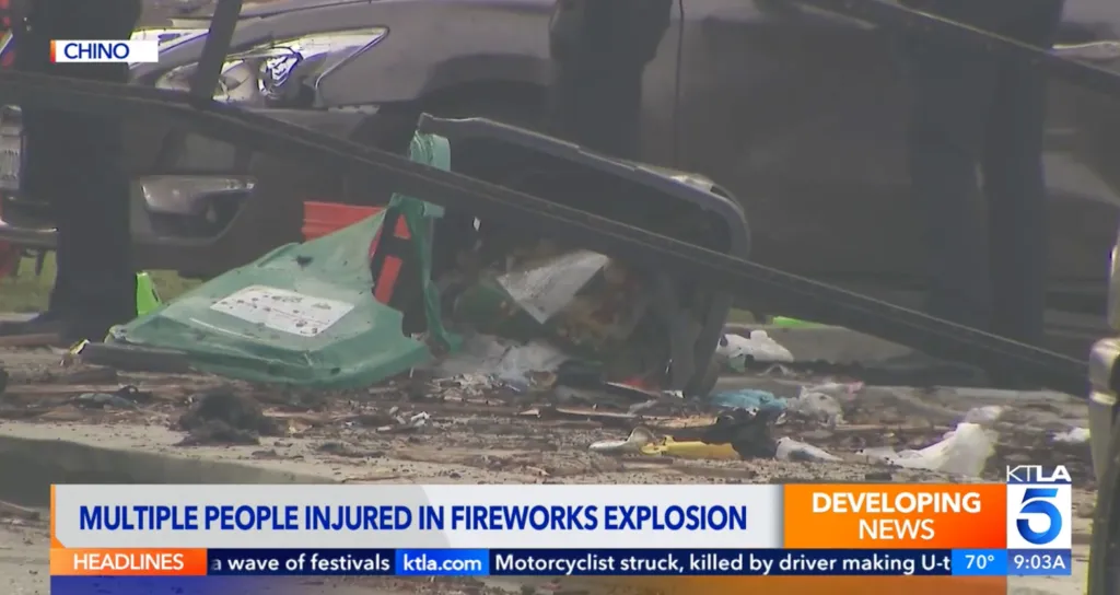 Debris on the street and damaged items, including a green trash can, after a fireworks explosion.