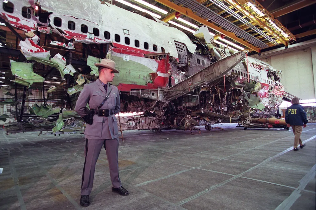 A New York State trooper guards the reconstructed wreckage of TWA flight 800.