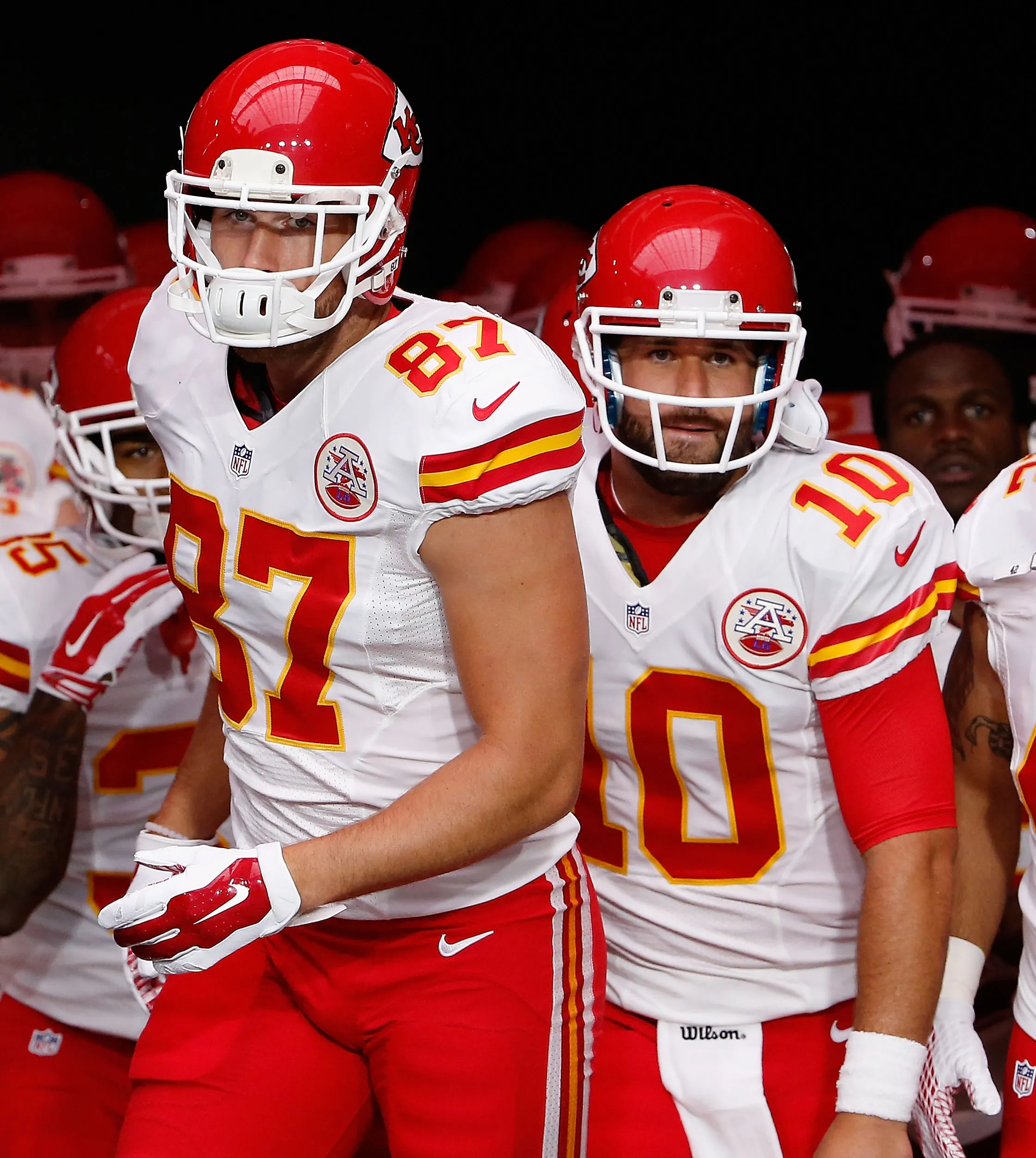 Travis Kelce #87 and Chase Daniel #10 of the Kansas City Chiefs in uniform walking onto the field.