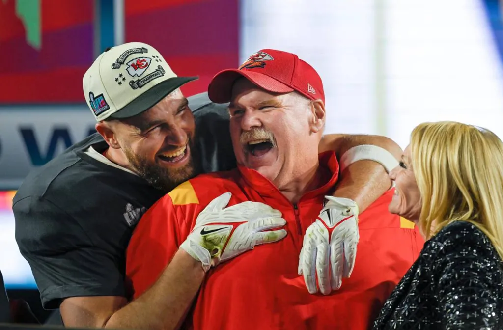 Kansas City Chiefs tight end Travis Kelce (87) hugs Chiefs Head Coach Andy Reid after the Chiefs won Super Bowl LVII.