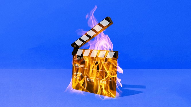 A movie clapperboard on fire