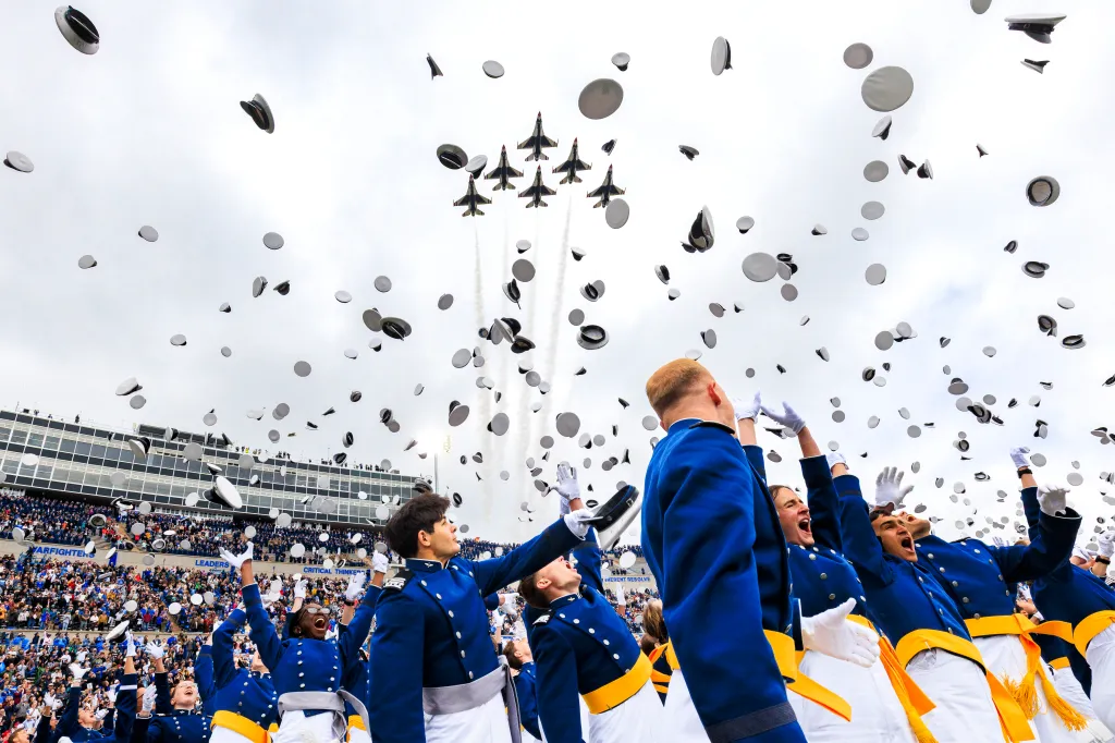 U.S. Air Force Academy cadets celebrate graduation by throwing their hats into the air during a flyover by the U.S. Air Force Thunderbirds.
