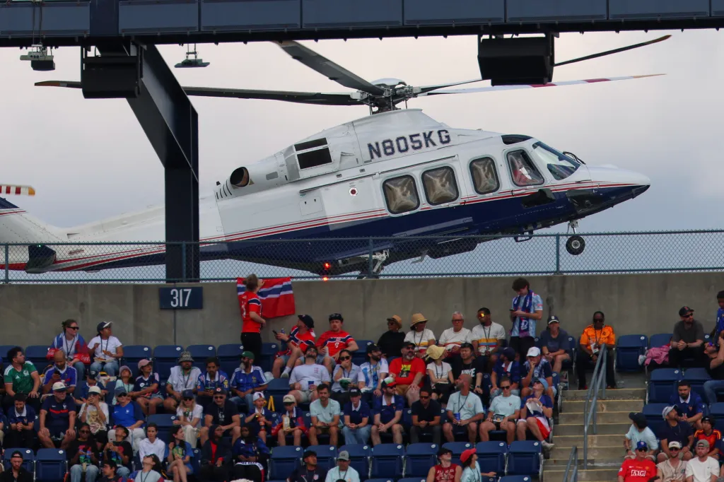 A helicopter lands next to the stadium during the World Cup 