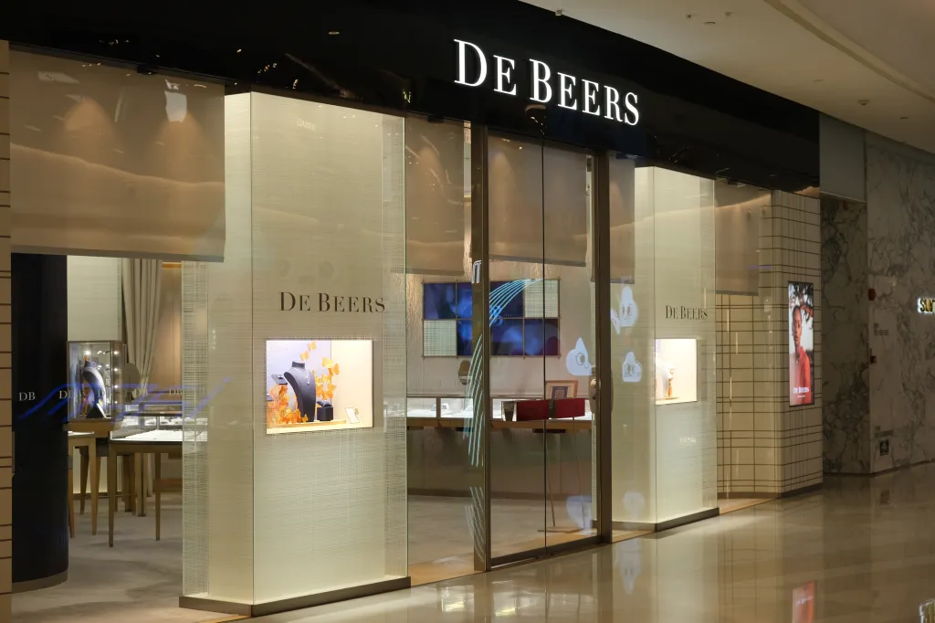 De Beers retail store front with jewelry displays in the windows.