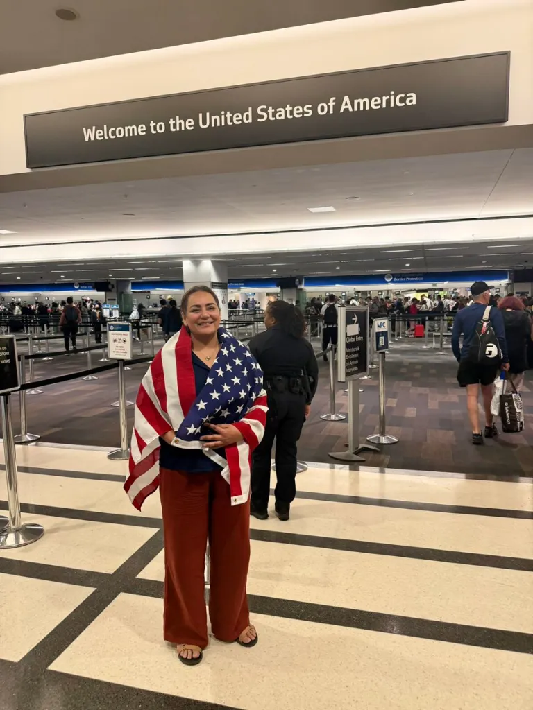 Dena Karari smiles after landing back in the US on July 18, 2026.