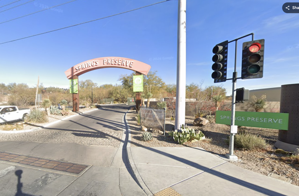 Entrance to Springs Preserve with a red light at the traffic signal.