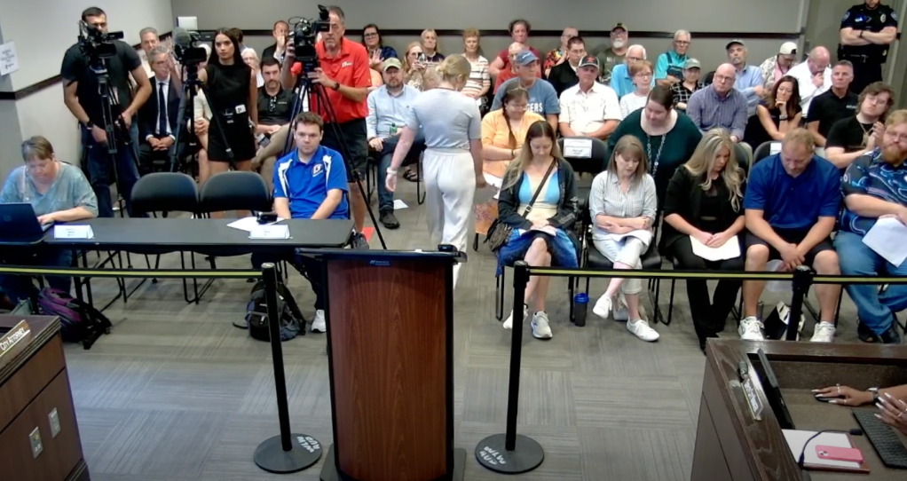 Lux Claridge was removed from the room for clapping after a woman gave comments during the meeting.