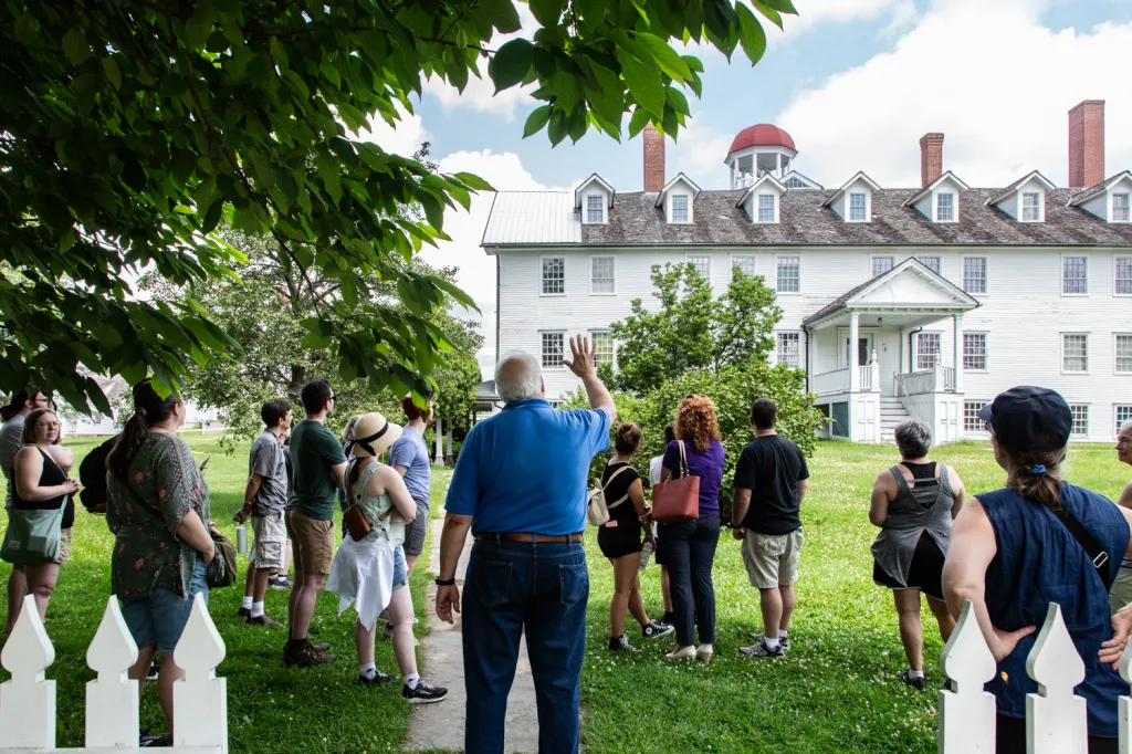 A guide leading a tour group at Canterbury Shaker Village.
