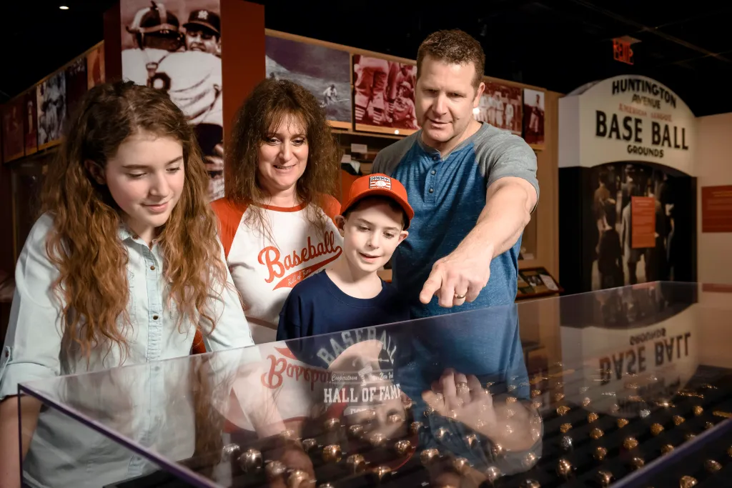 A family of four looking at World Series rings on display in a museum.