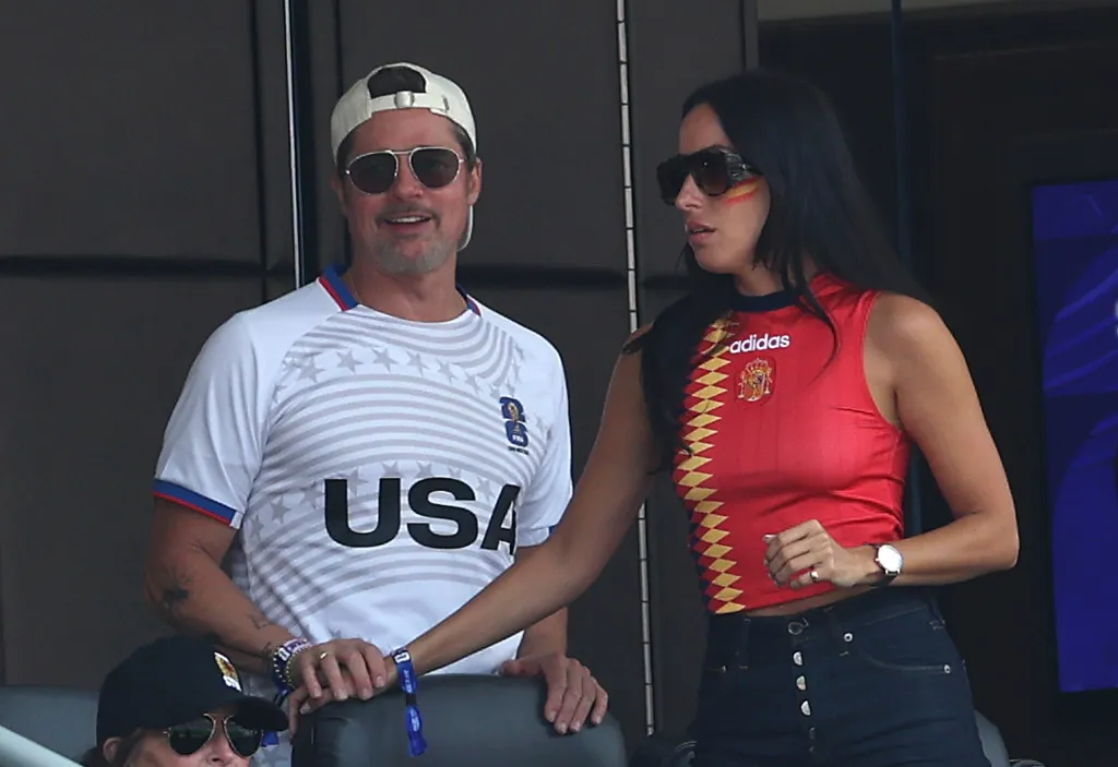 Brad Pitt wearing a USA shirt and Ines de Ramon in a Spain shirt watch the FIFA World Cup.