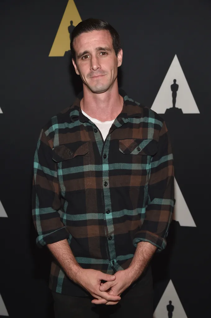 Actor James Ransone in a plaid shirt with hands clasped.
