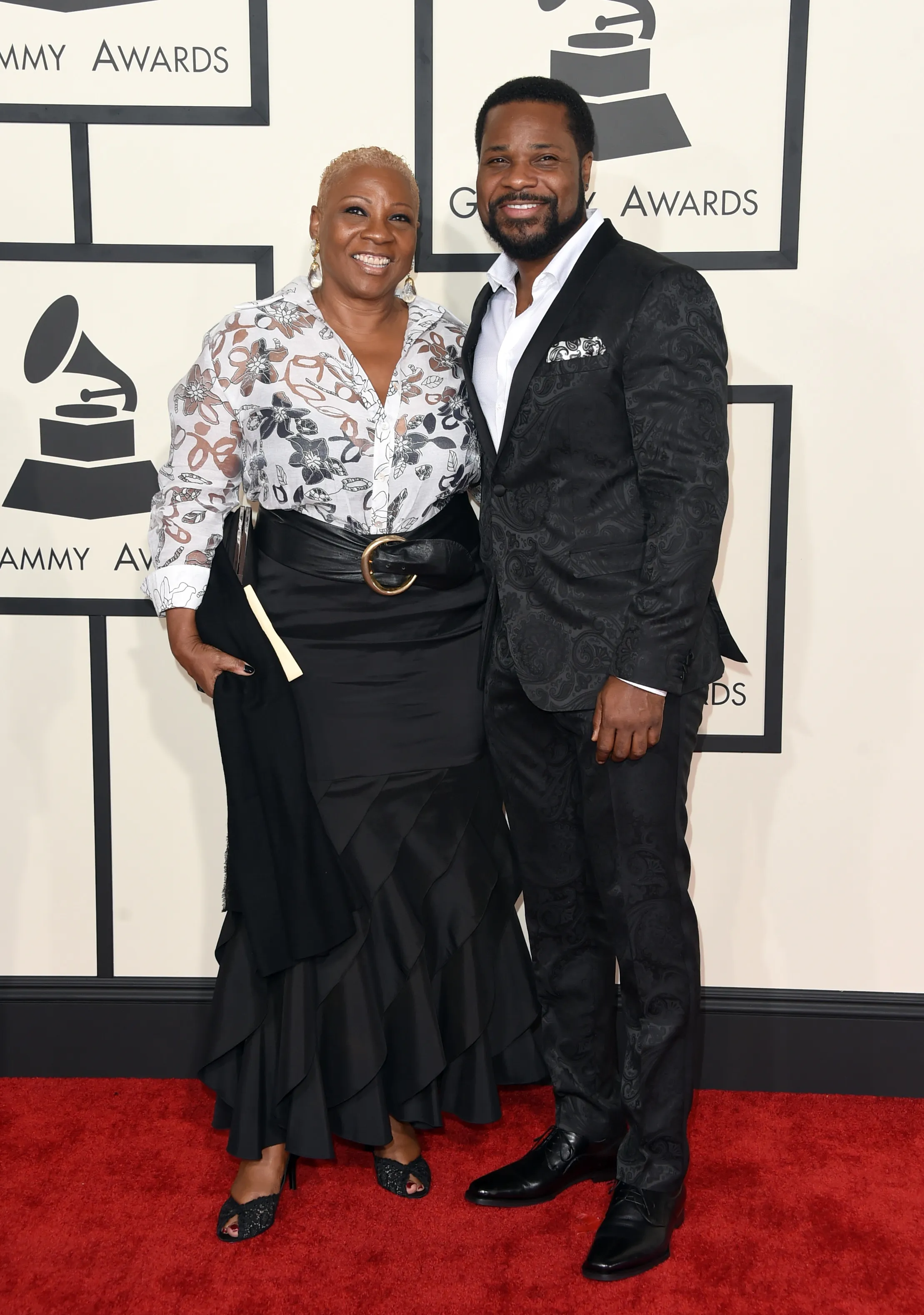 Actor Malcolm-Jamal Warner and Pamela Warner pose on the red carpet at the 57th Annual GRAMMY Awards.