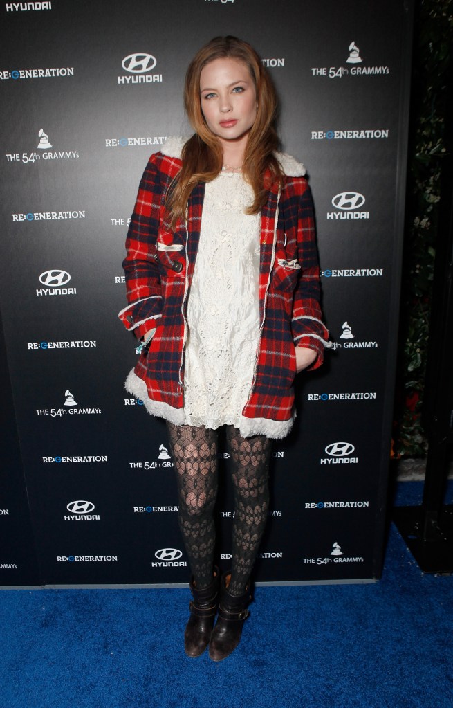 Daveigh Chase poses in a plaid jacket, white dress, and patterned tights at the Hyundai and GRAMMY's RE:GENERATION MUSIC PROJECT World Premiere.