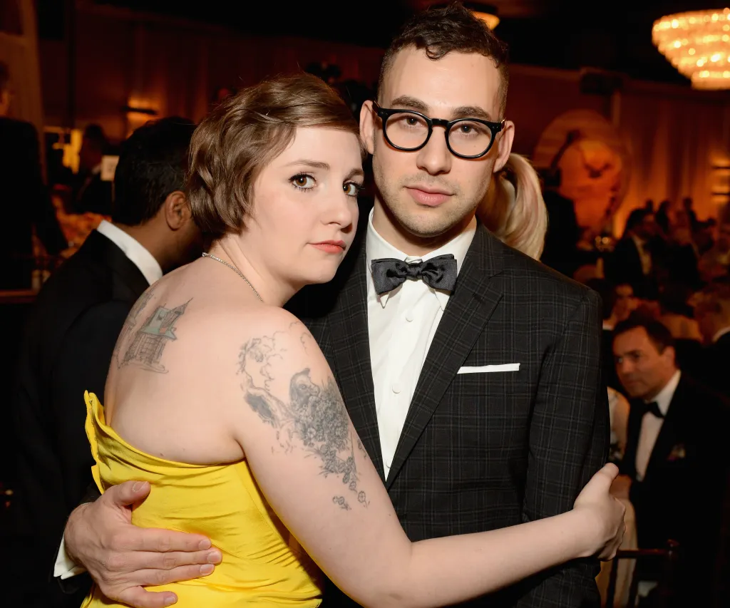 Lena Dunham, in a yellow dress, with musician Jack Antonoff, in a checkered suit and bow tie, at the 71st Annual Golden Globe Awards.