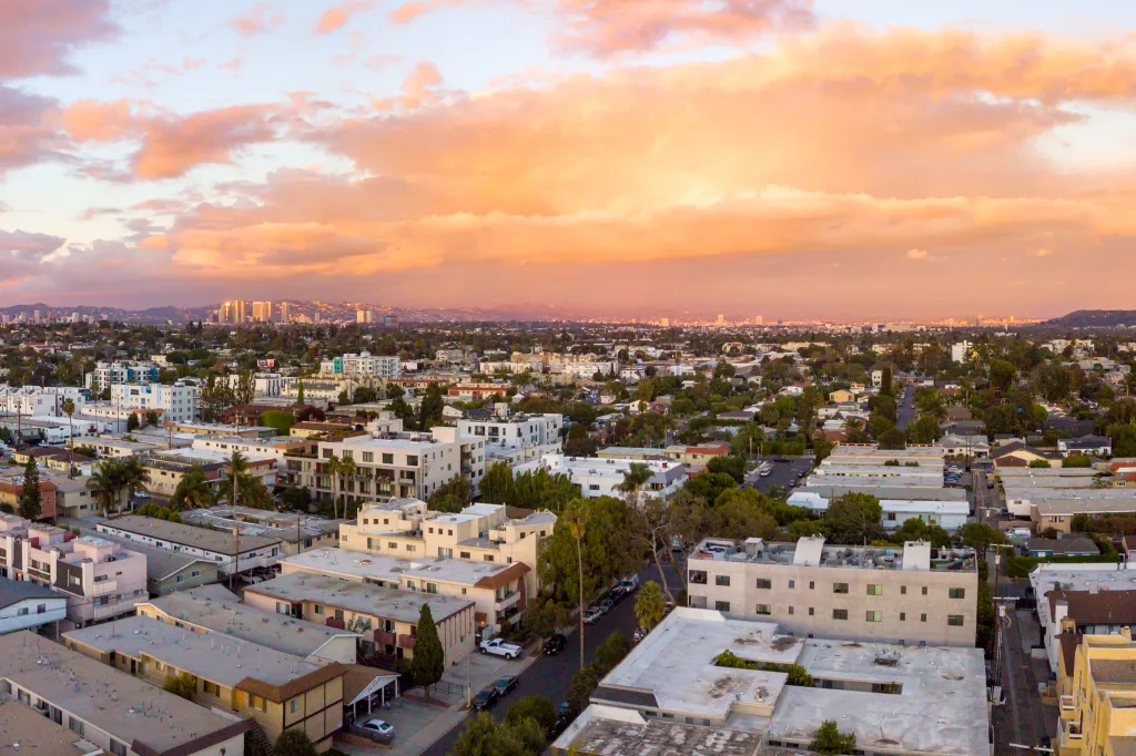 Aerial view of the Mar Vista neighborhood in Los Angeles with the Santa Monica mountains in the background during sunset.