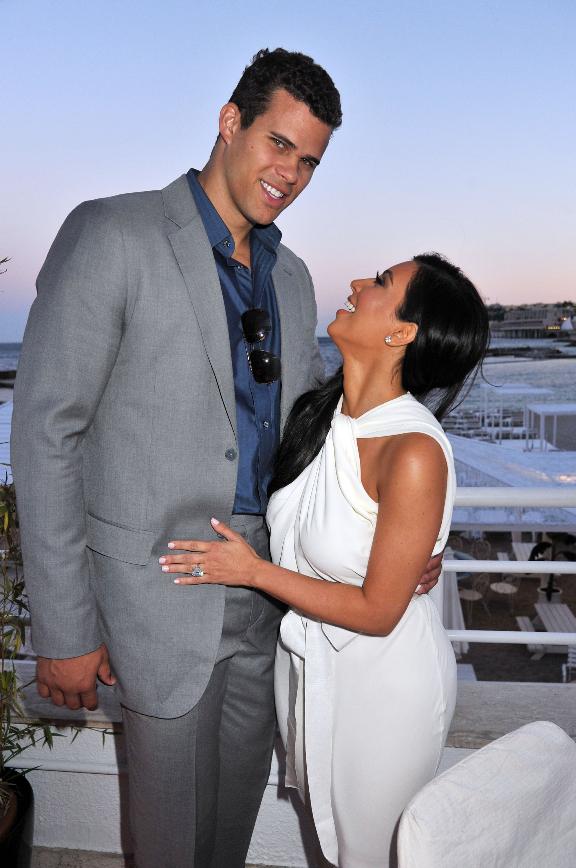 Kim Kardashian and Kris Humphries posing together, with Kardashian looking up at Humphries and smiling.