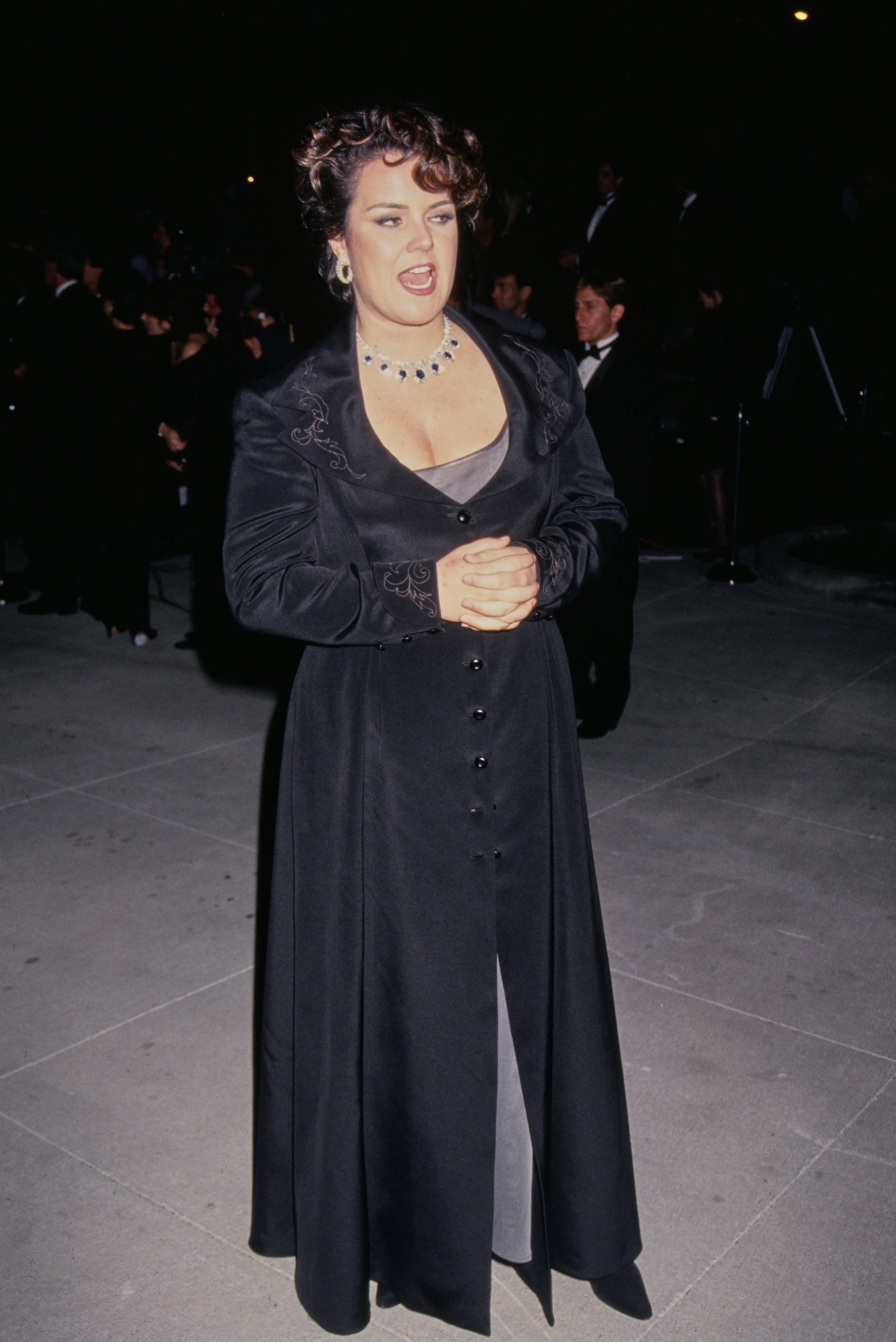 American actress Rosie O'Donnell attending the 66th Academy Awards in a black dress with embroidered sleeves and a statement necklace.