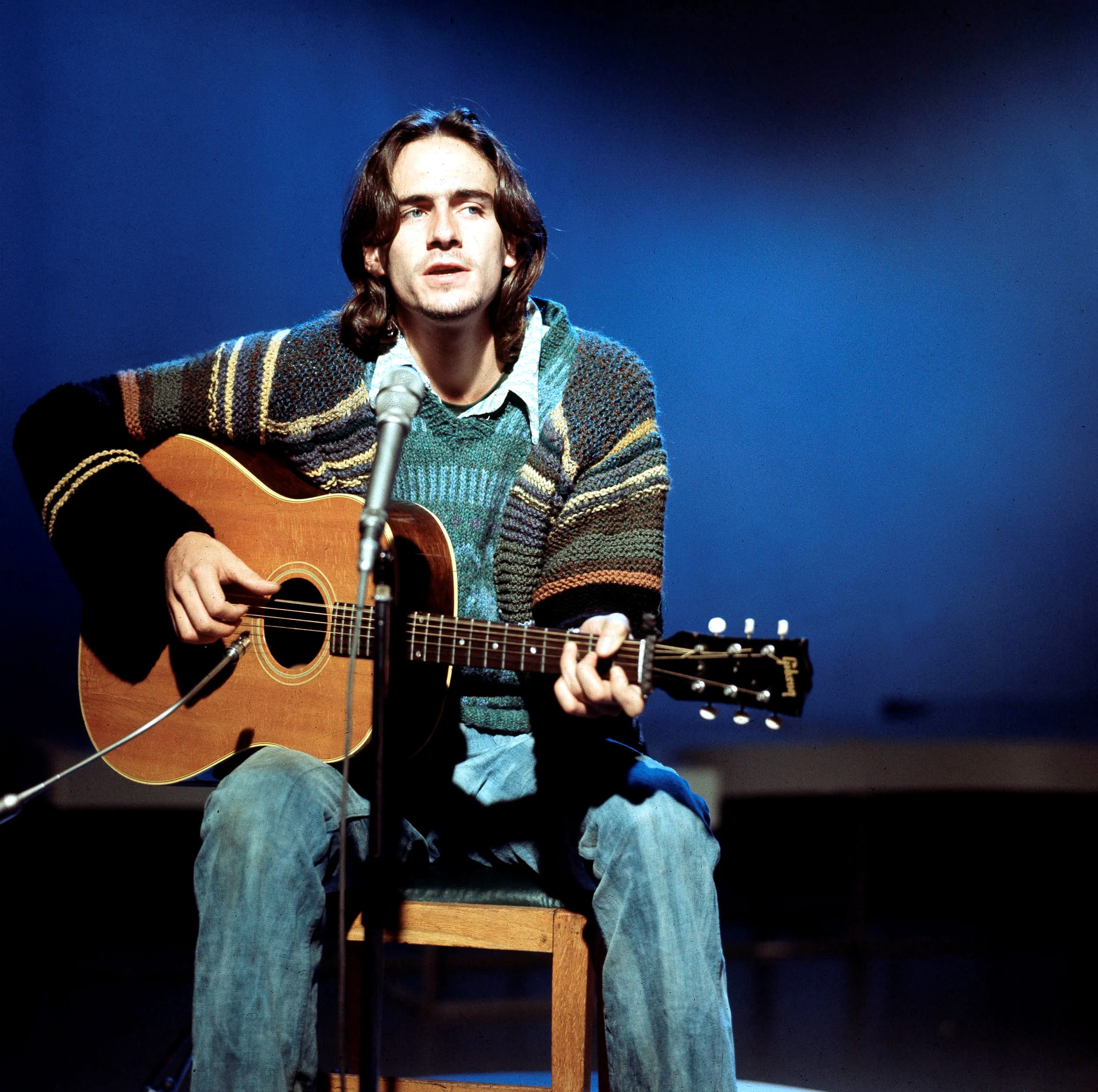 American singer-songwriter James Taylor performing live with his guitar.