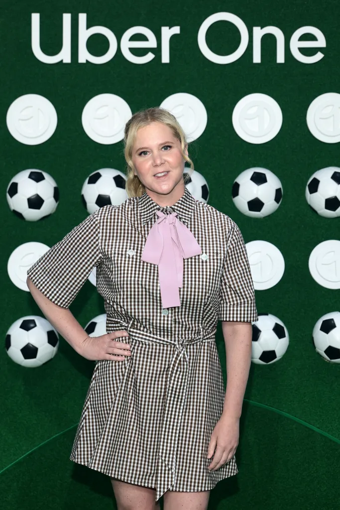 Amy Schumer smiling at "The One Party by Uber" event.
