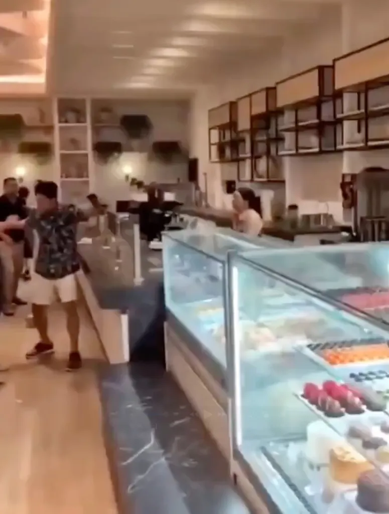 A hotel employee having an emotional collapse, throwing items at guests in a hotel resort.