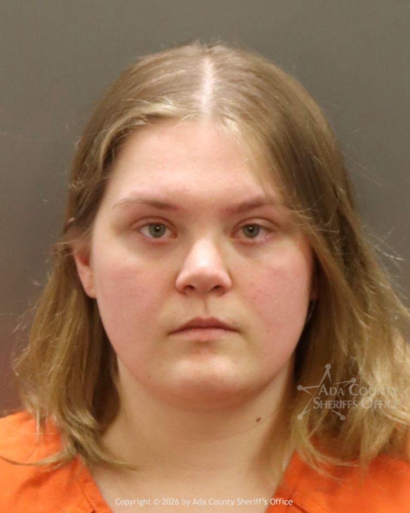 Mugshot of Andrea Shaw, a 23-year-old woman with blonde hair wearing an orange shirt.