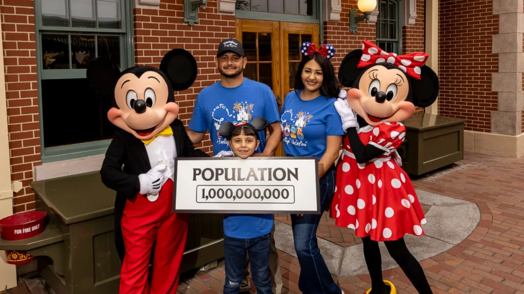 Andres Robles and family with Mickey and Minnie Mouse celebrating being Disneyland's 1 billionth guest.