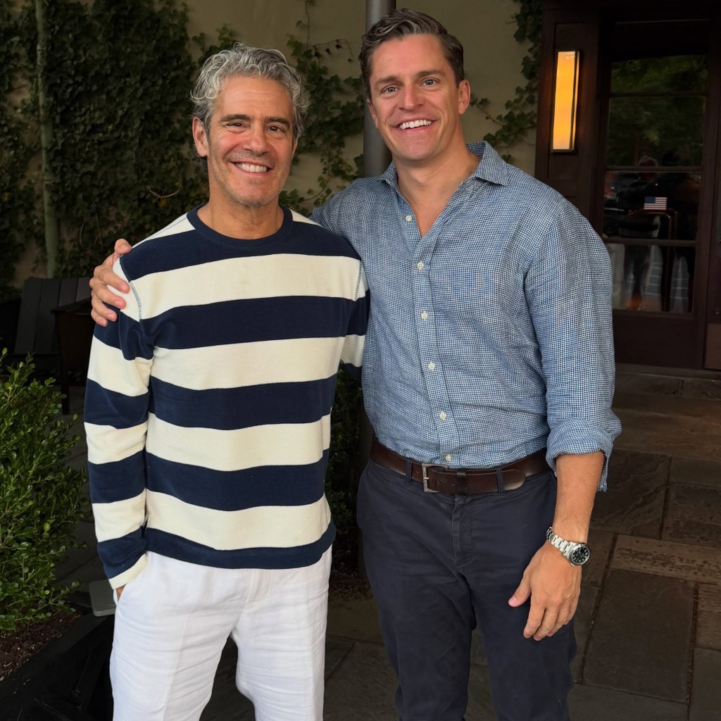 Andy Cohen and Kevin Sobieski smiling, with Sobieski's arm around Cohen.