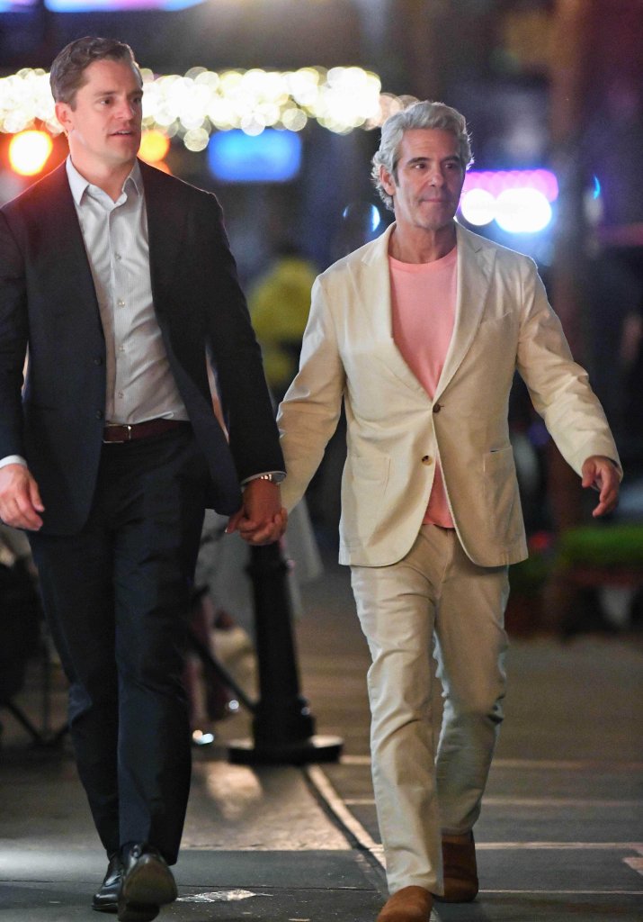 Andy Cohen and Kevin Sobieski holding hands while walking after dinner.