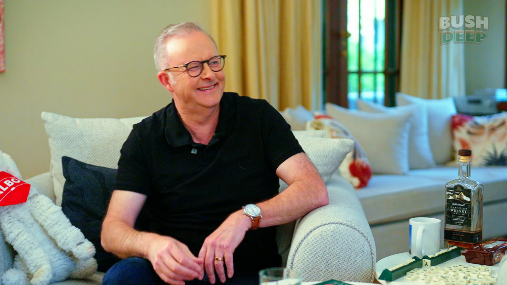 Anthony Albanese smiling while sitting on a couch.