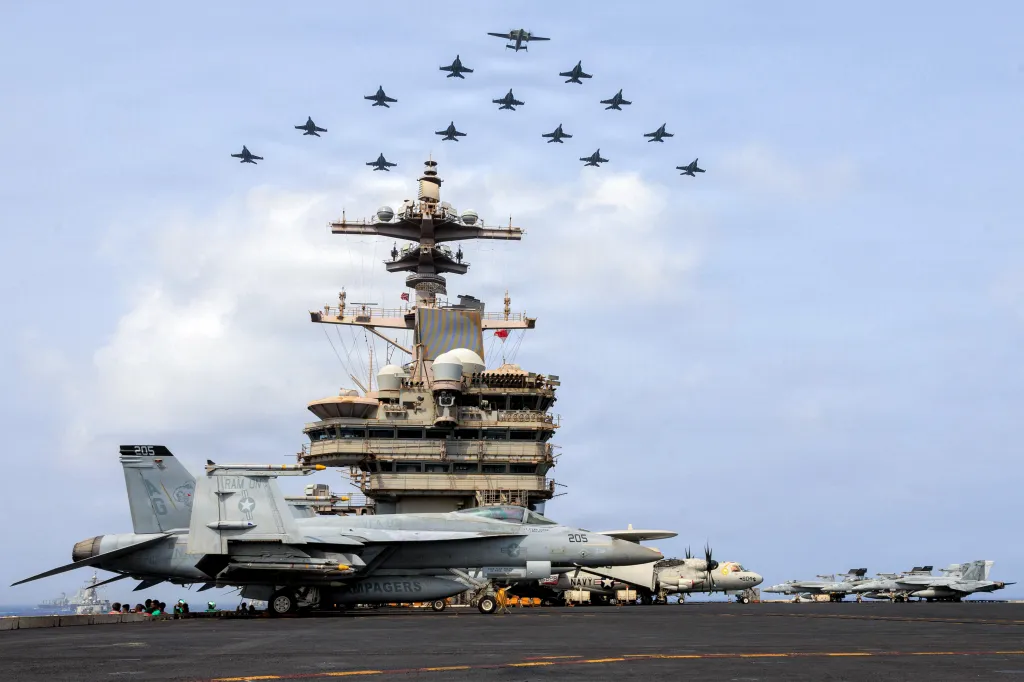 The Carrier Air Wing (CVW) 7 flying in formation over the USS George H.W. Bush (CVN 77) in the Arabian Sea.