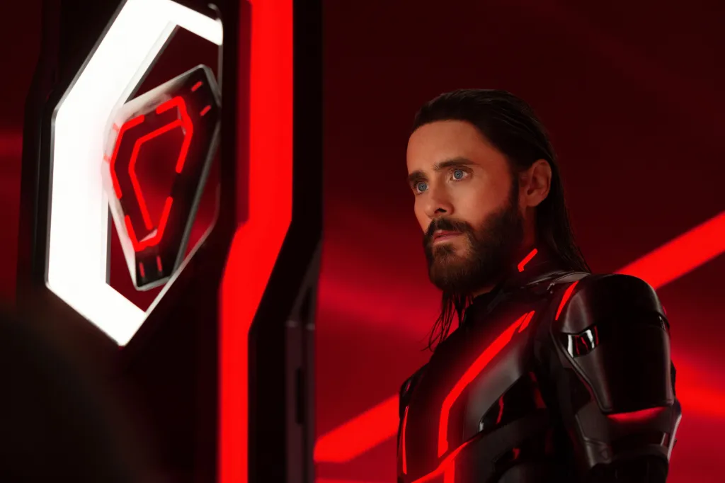 Jared Leto as Ares in "Tron: Ares," wearing a black suit with glowing red lines.