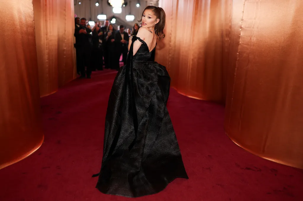 Ariana Grande in a black off-the-shoulder gown on the red carpet at the Golden Globes.