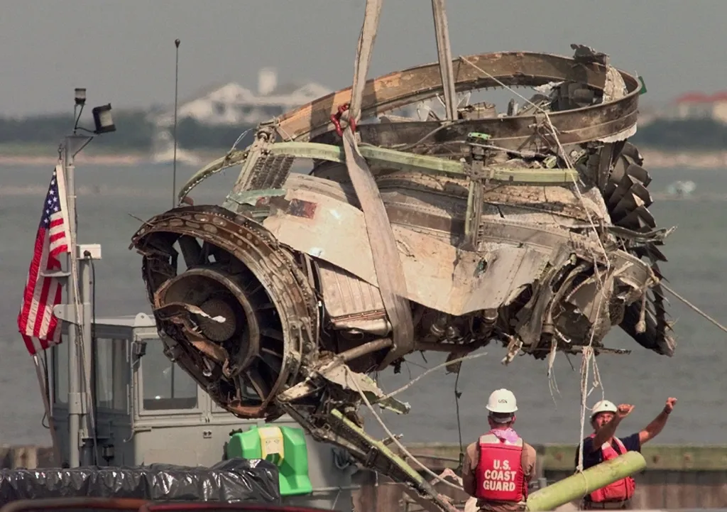 Army National Guardsmen guide a retrieved engine from TWA Flight 800 off a barge at the U.S. Coast Guard Station.