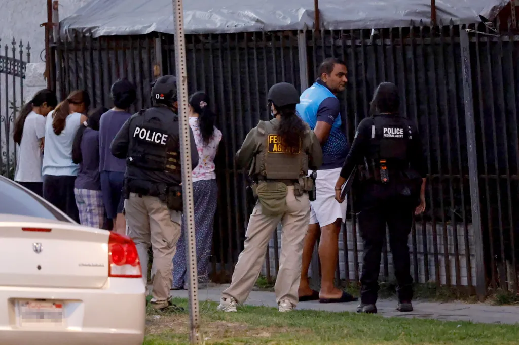 Police and federal agents arrest a motel manager and others during a raid.