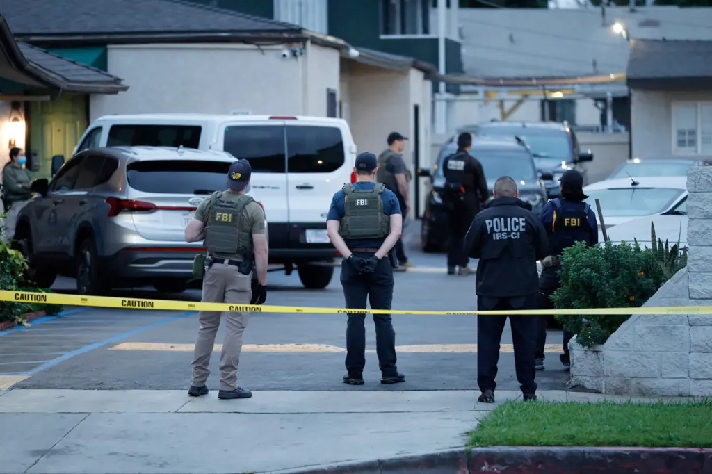 FBI and IRS-CI agents at a motel during a raid.