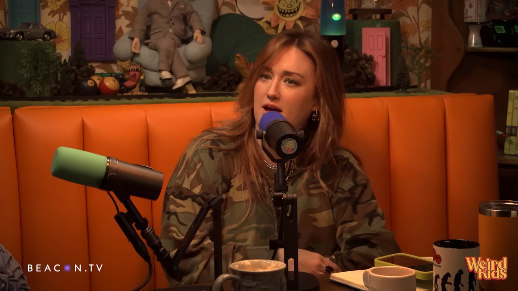 Ashley Johnson speaking into a microphone.